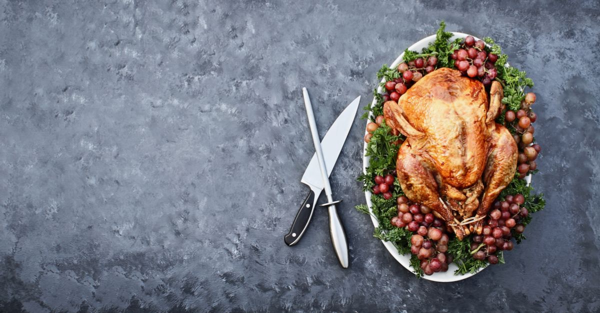 Turkey from overhead next to a carving knife and sharpener