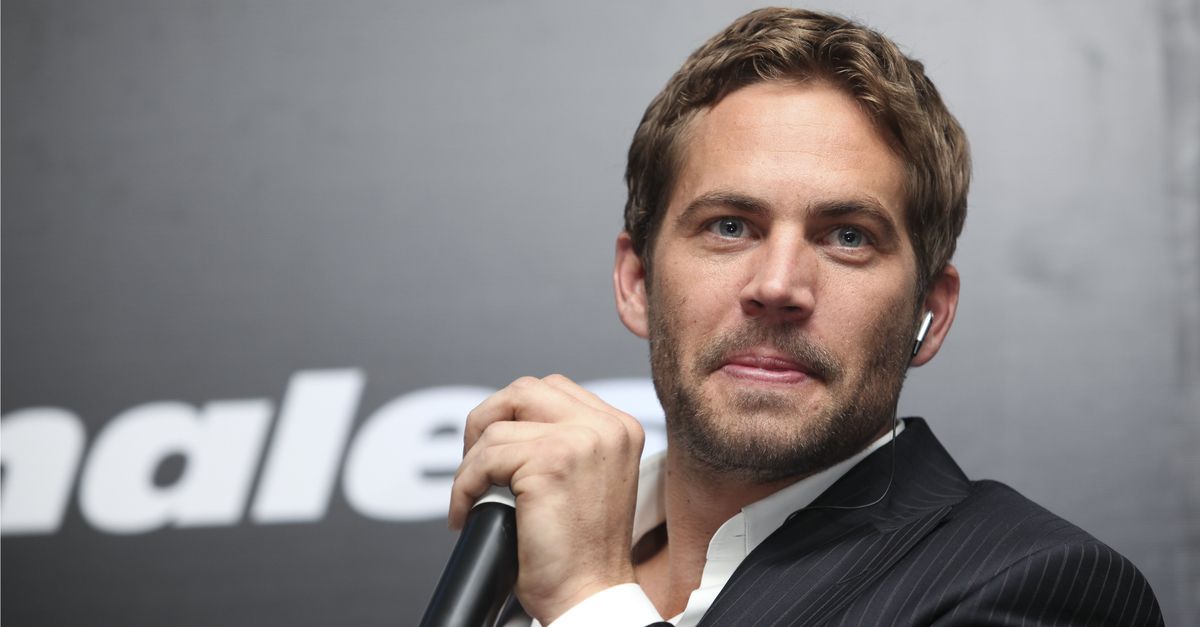 Paul Walker holding a microphone during an interview, 2009