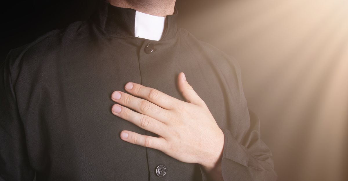 Catholic priest praying