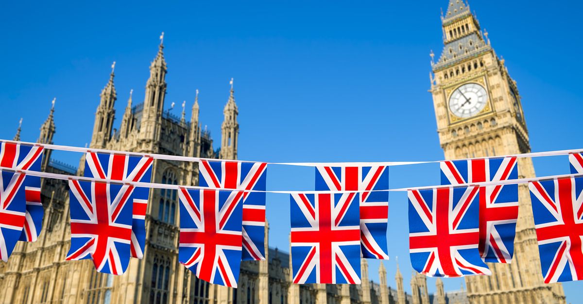 Union Jack flags strung across a road in front of Big Ben