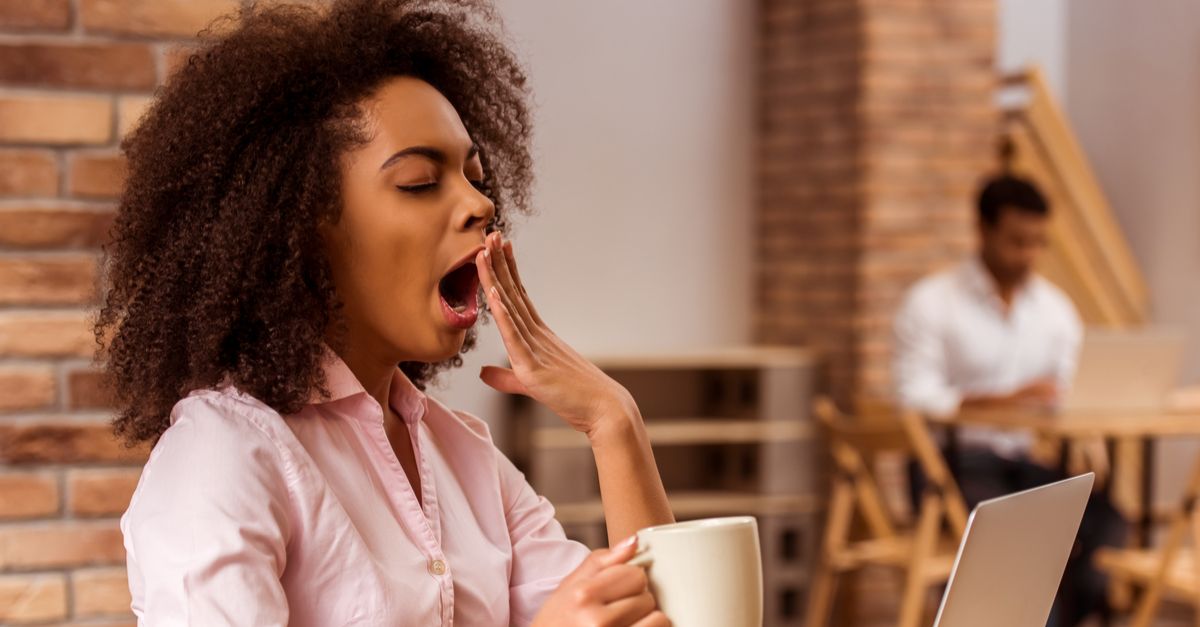 Woman wearing pink shirt yawning