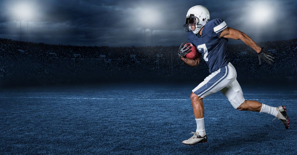 American football player running across a stylized field at night
