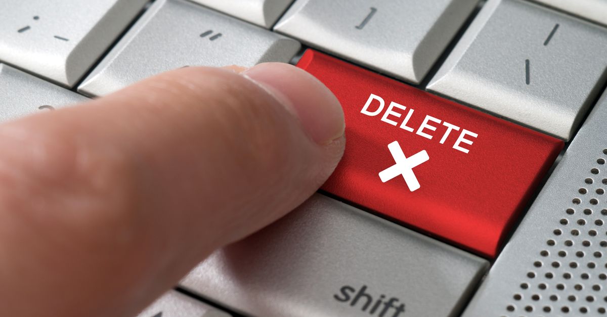 Close-up of finger pressing "Delete" key