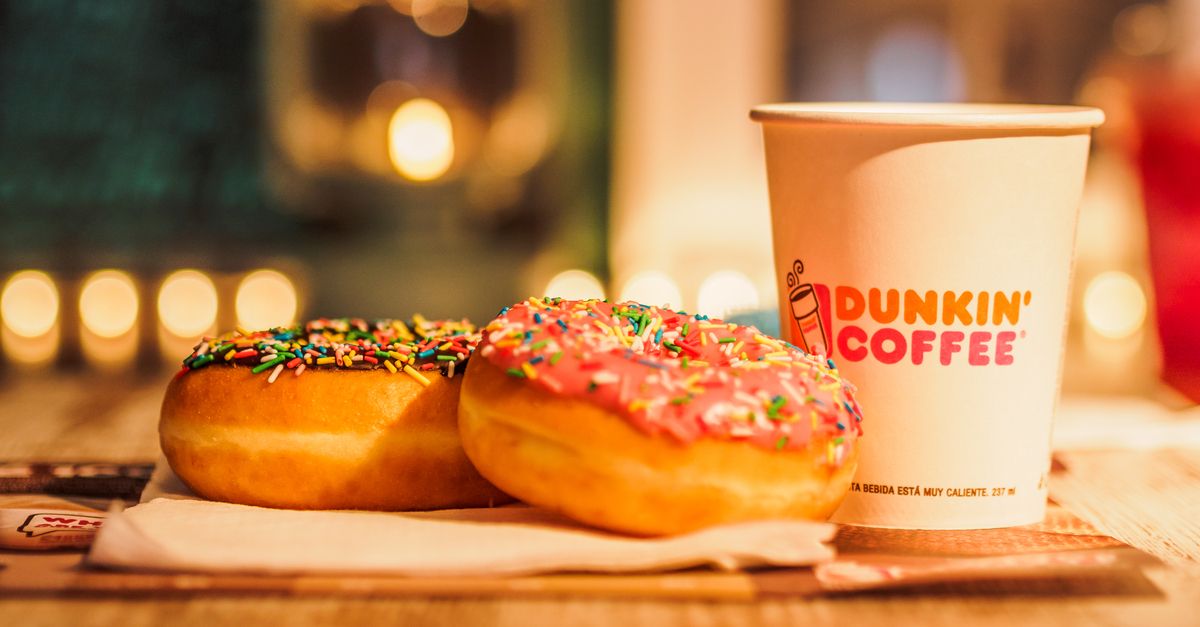 Donuts next to a Dunkin' Donuts cup