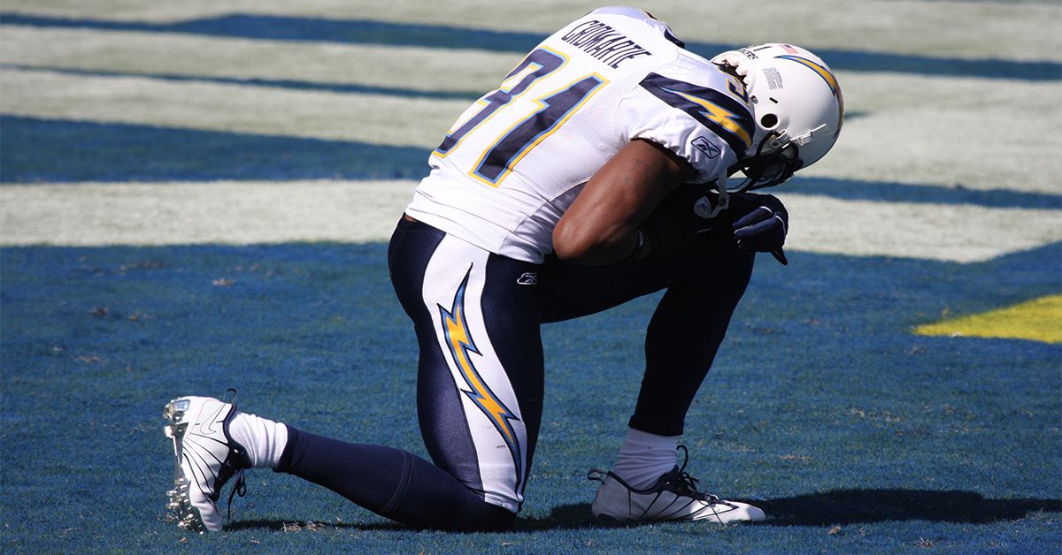 Football player kneeling.