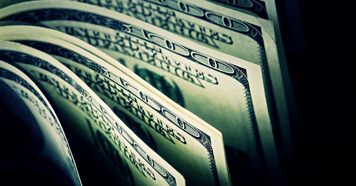 $100 US Dollar bills in dark background