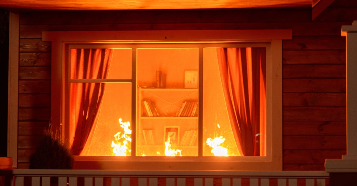 House fire viewed through window from outside.