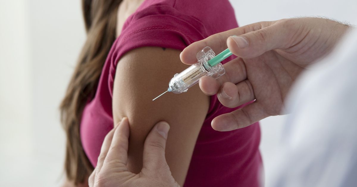 Young woman receiving an injection.