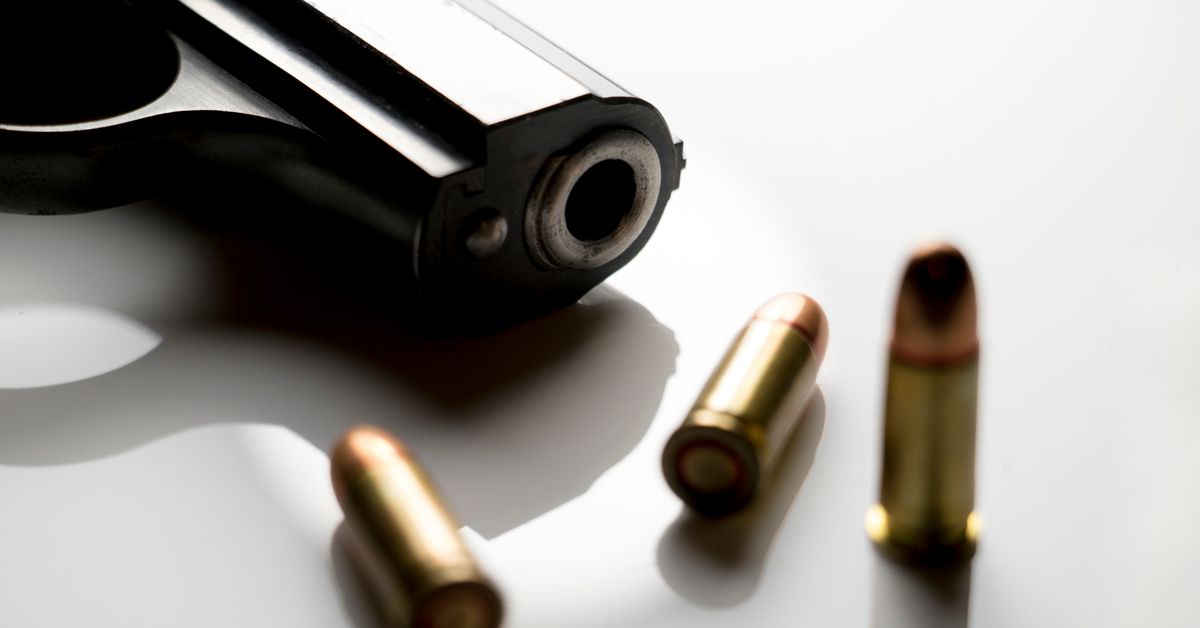 Close-up of a gun muzzle with bullet casings.