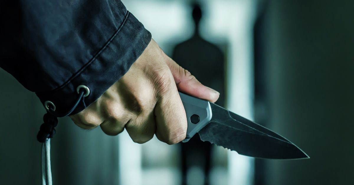 Hand holding a small knife.