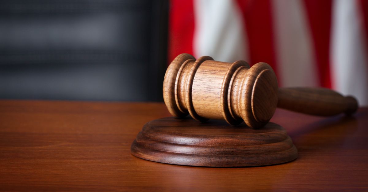 Gavel resting on judge's bench in a courtroom.