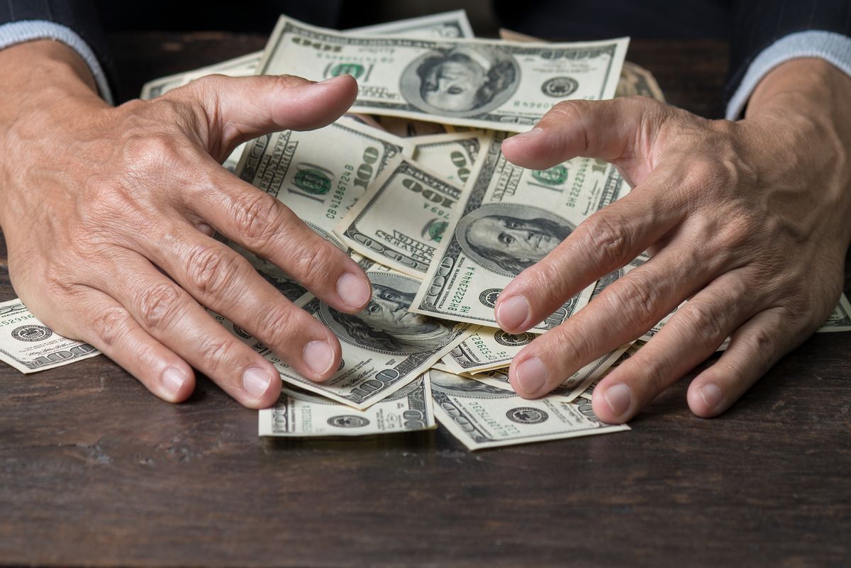 Close-Up Of A Person With A Load Of Money
