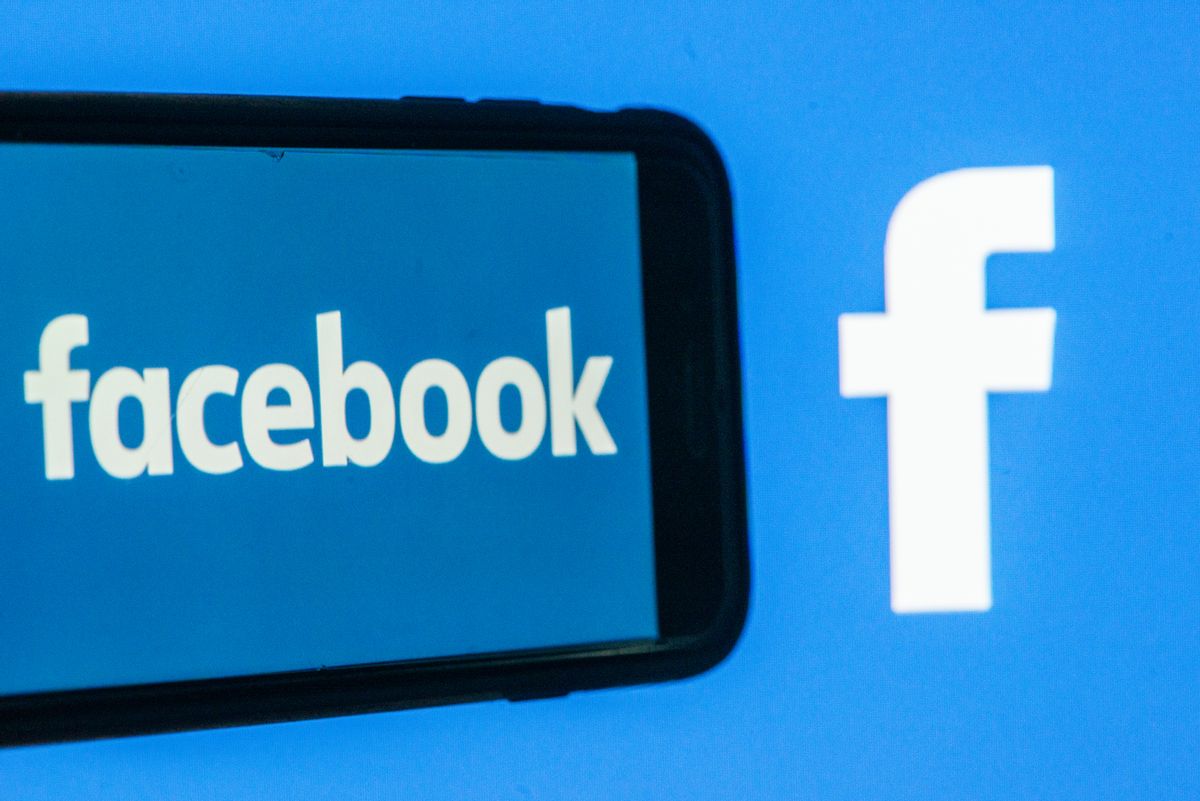 A phone that says Facebook is next to the Facebook logo.