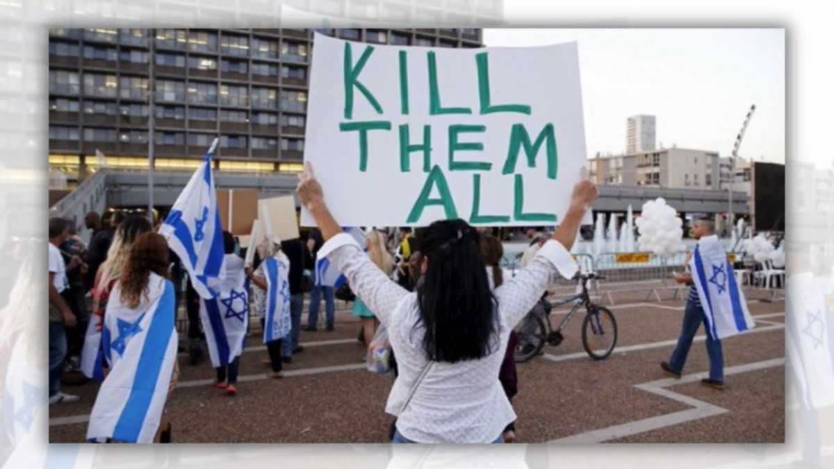 A person in a white shirt stands in front of a building while holding a sign that says, "KILL THEM ALL." Surrounding the sign-holder are several people, some of which are holding or wearing Israeli flags.
