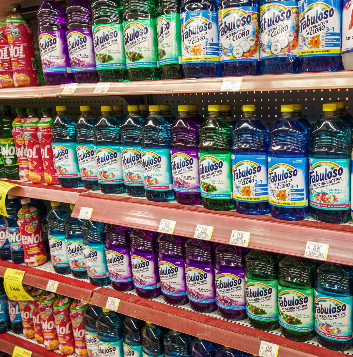 Rows of colorful Fabuloso cleaner bottles on supermarket shelves. 