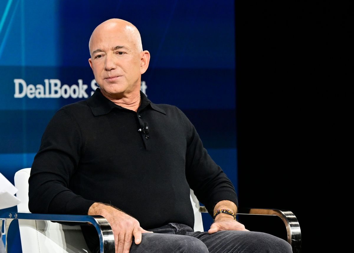 A white man sits in a chair.