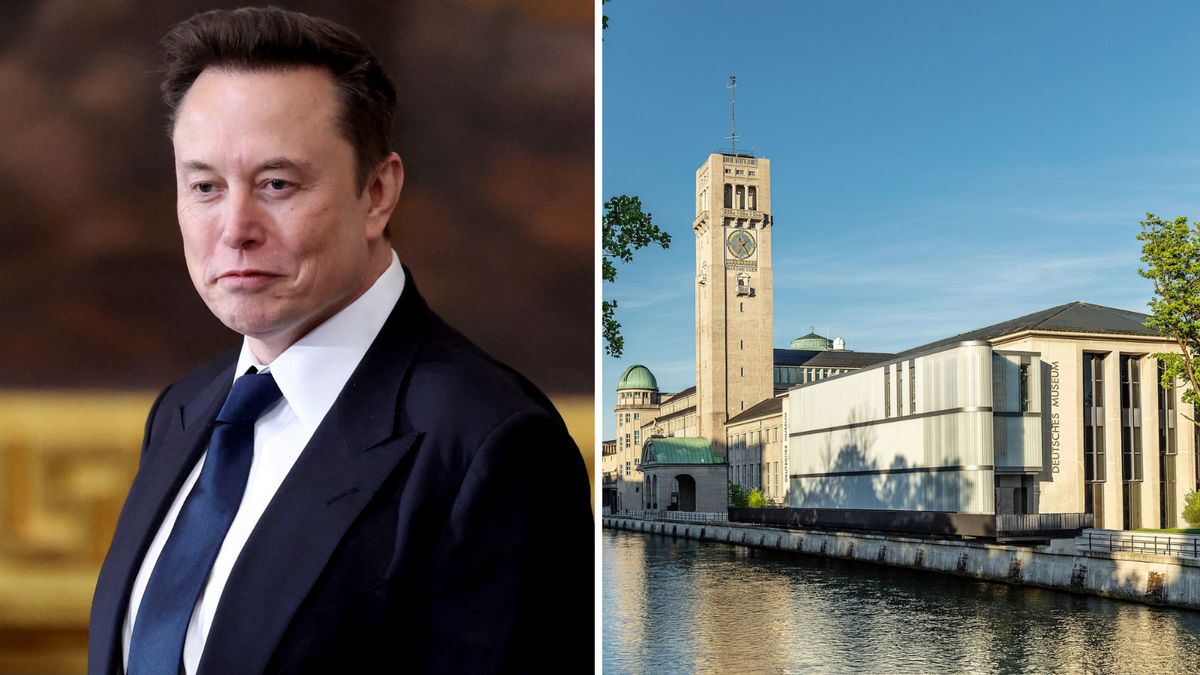 A white man wearing a blue suit is pictured next to a large building pictured along a body of water.