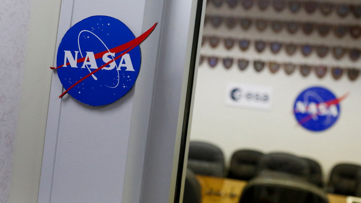 A doorway shows a blue sign with NASA in white on it. You can see seats in a room that has the same blue logo on it.