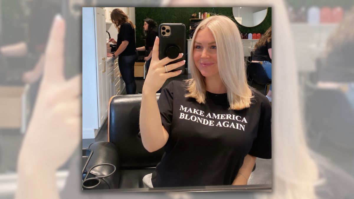 A white blonde woman wears a "MAKE AMERICA BLONDE AGAIN" T-shirt in a selfie.