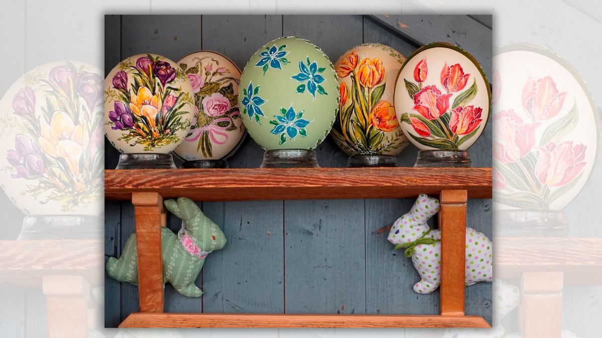 Decorated eggs are shown on a wood shelf above two bunny figurines.