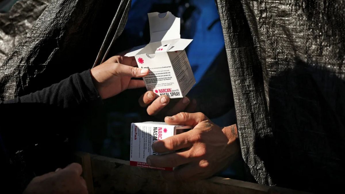 A box of Narcan exchanges hands. 
