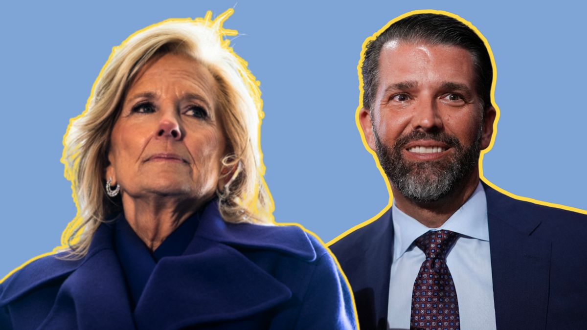 A white woman is pictured next to a white man. The woman wears a dark blue jacket, while the man wears a dark blue suit.