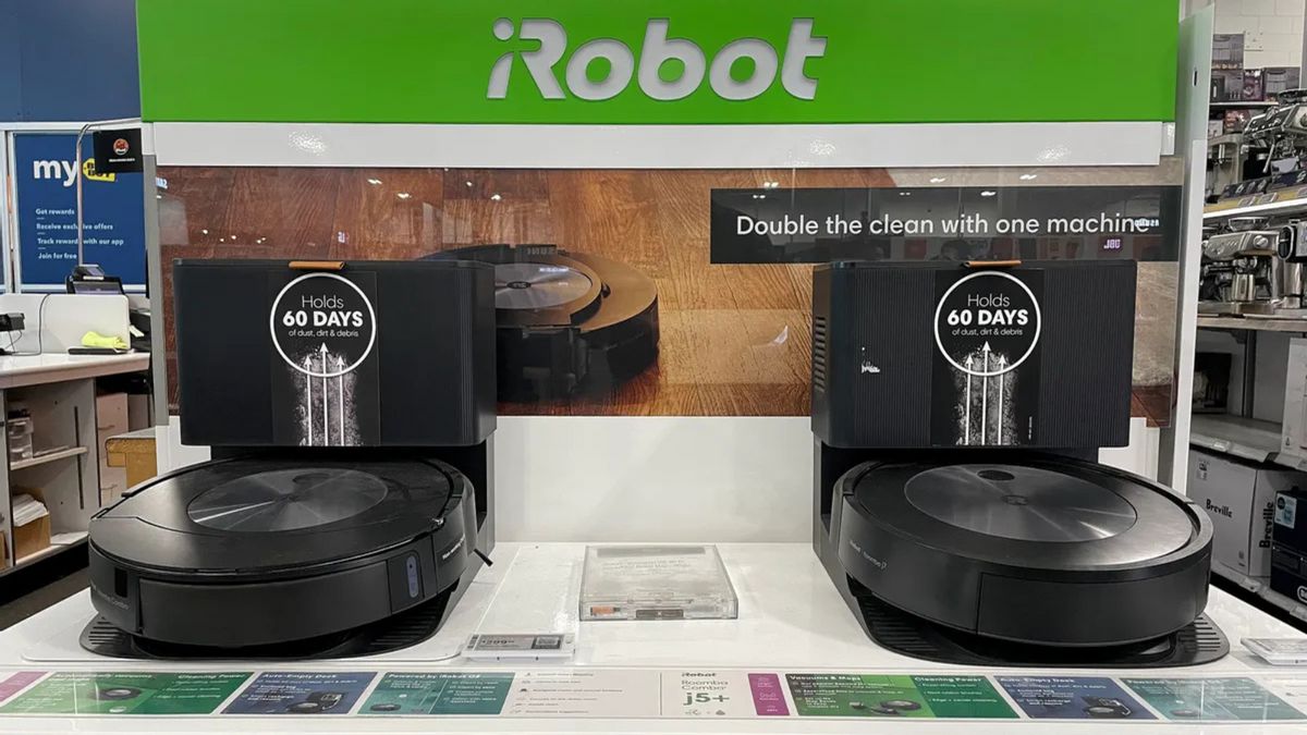 Two robot vacuums are displayed. Above, white text on a green sign says, "Robot."