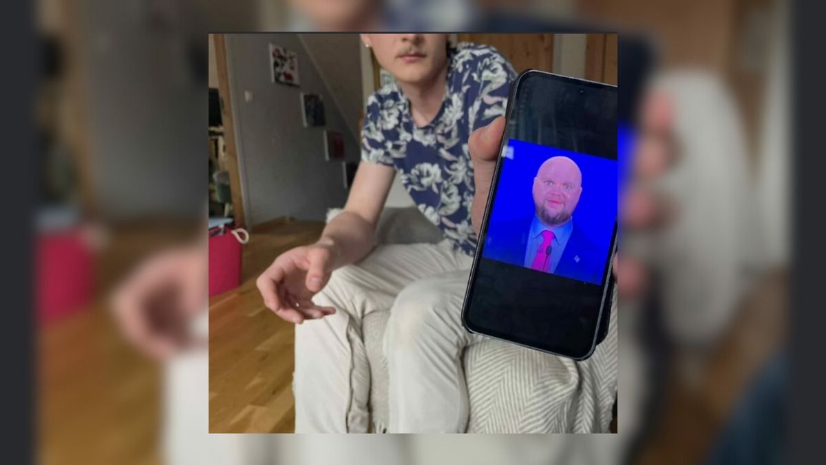 Person is shown holding a phone featuring bald JD vance meme