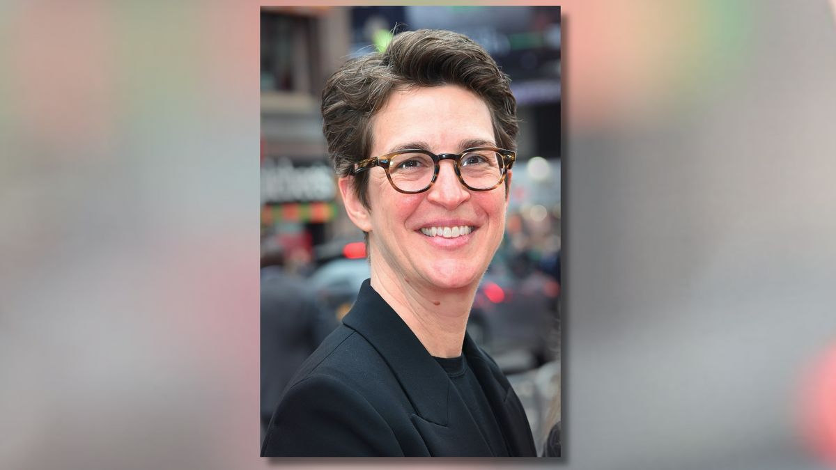 A white woman smiles at the camera.