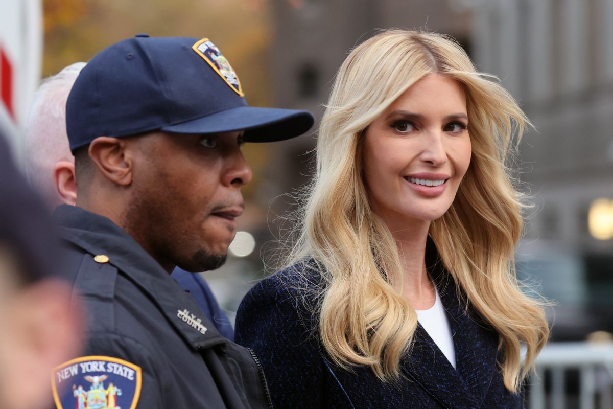 A white woman smiles at the camera as she stands next to a Black person wearing a dark blue uniform that says NEW YORK STATE.