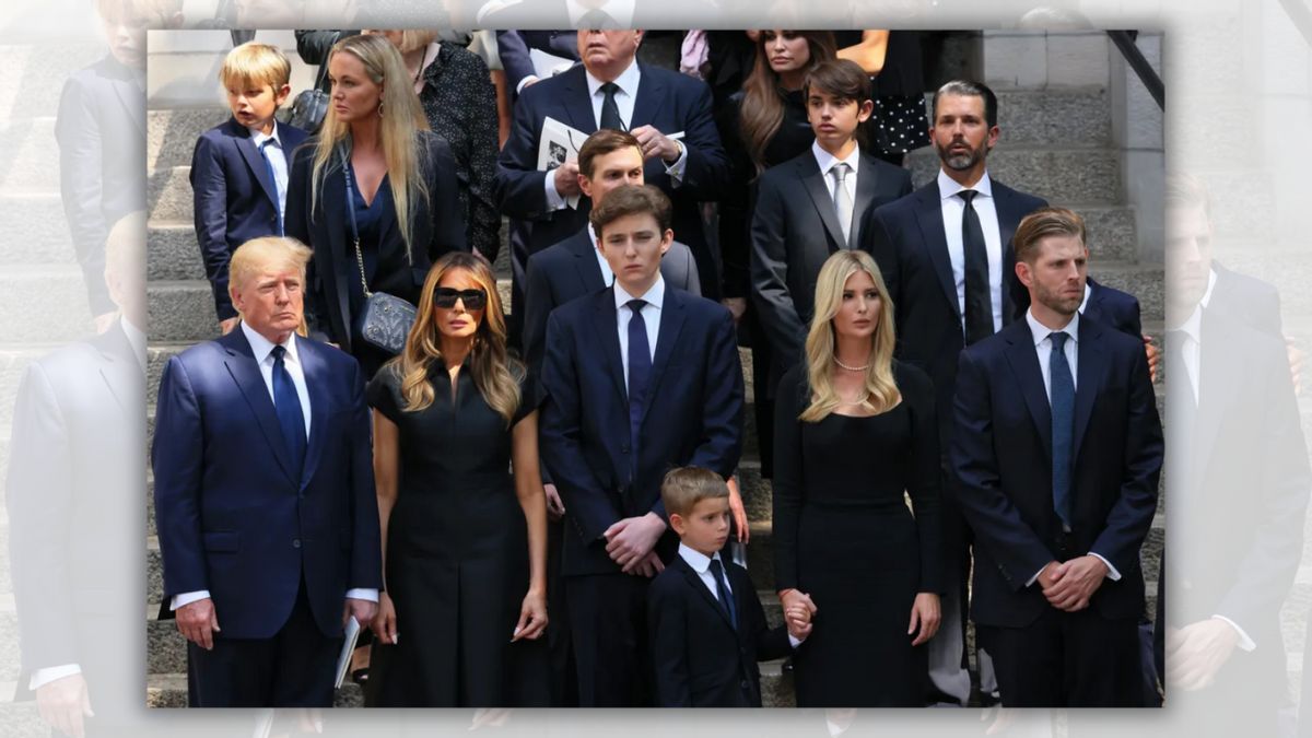 A group of people wearing formal attire stand in a group. 