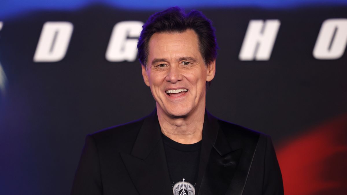 A middle-aged white man with short brown hair and an open-mouthed smile.