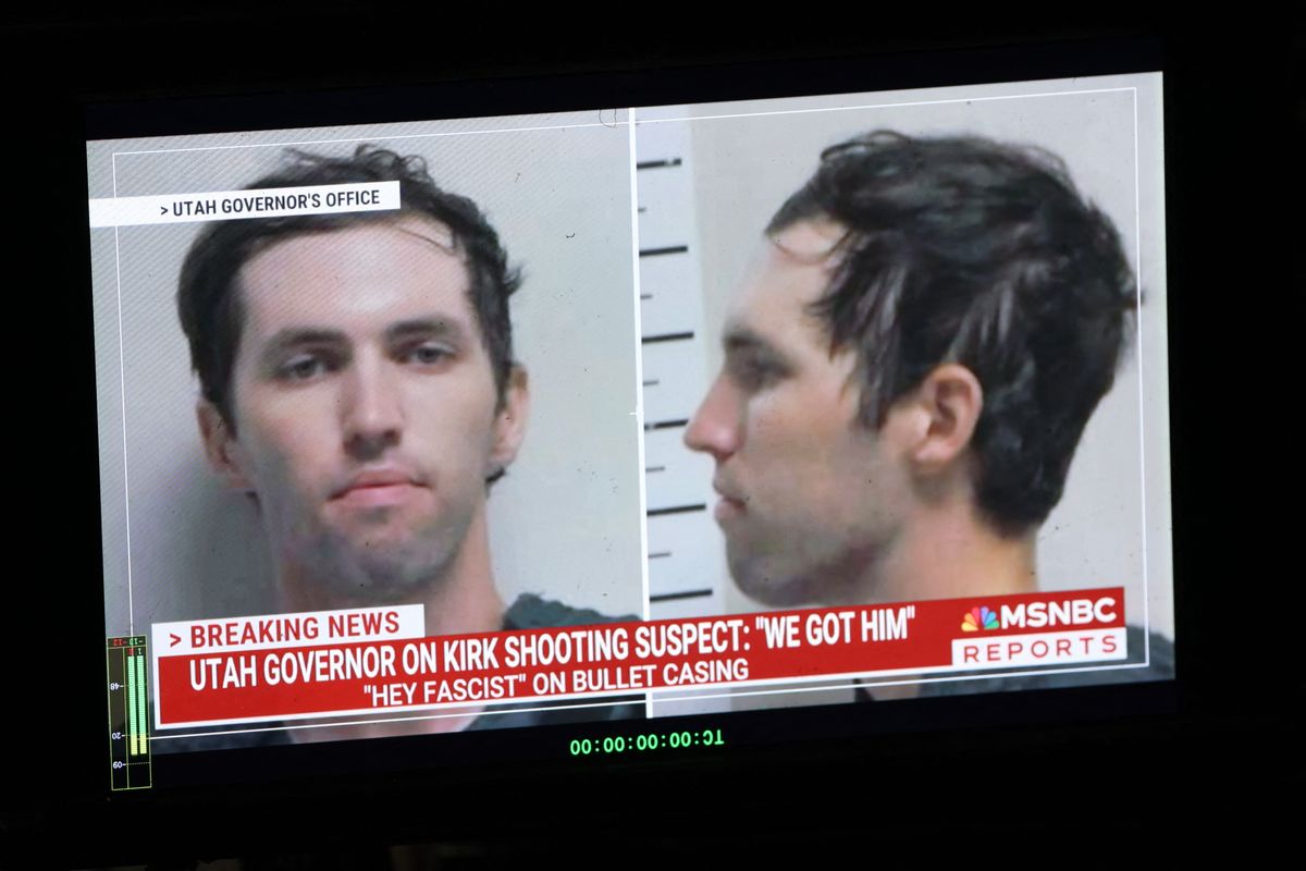 A mugshot of a young white man with short brown hair is shown on a TV news broadcast. 