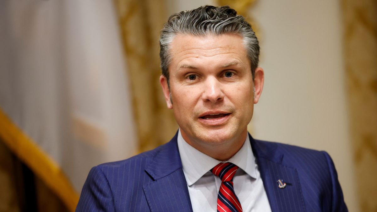 Pete Hegseth, a white man wearing a blue suit, appears to be speaking.