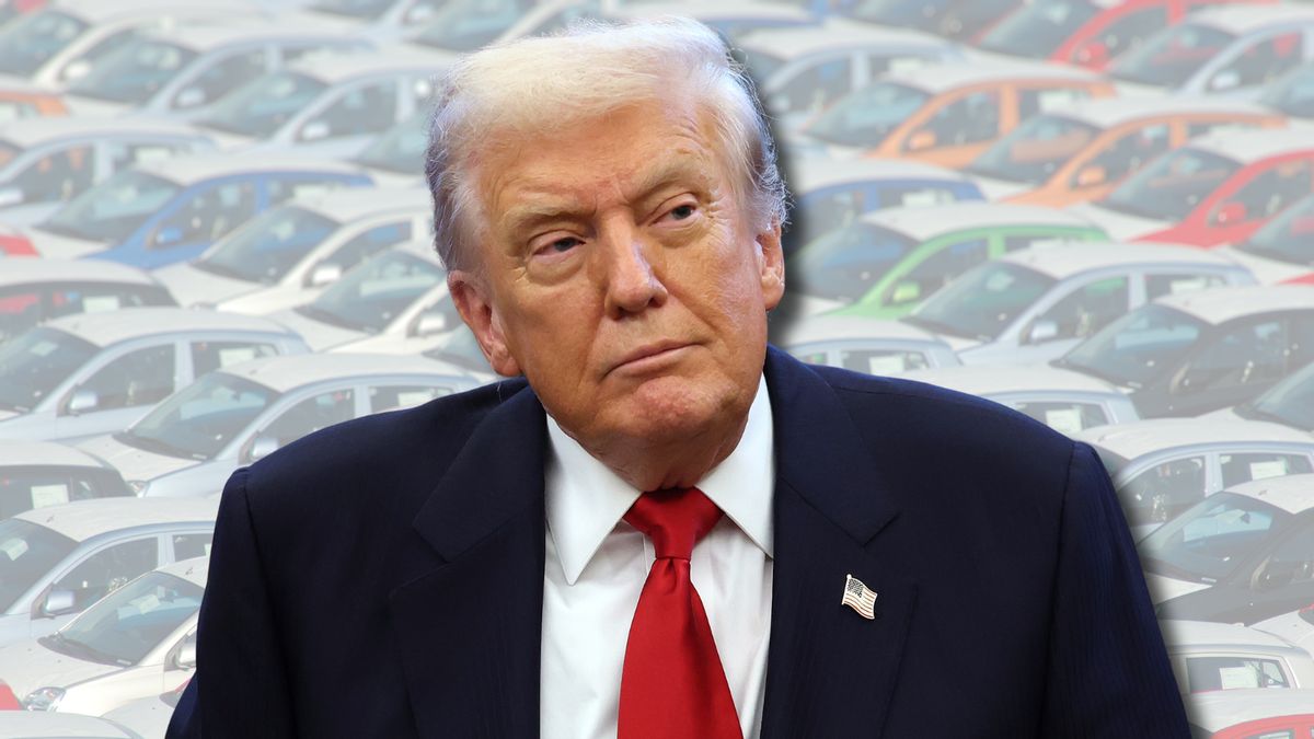 A white man wearing a dark suit is pictured. Different colored cars can be seen in the background.