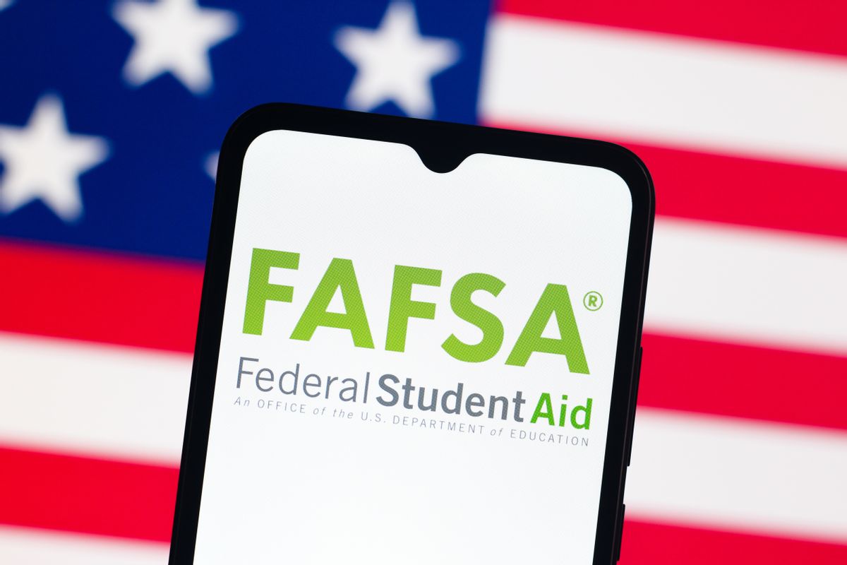 Photo illustration of the U.S. flag in the backdrop and a smartphone that has the words "FAFSA" on it in the foreground. 