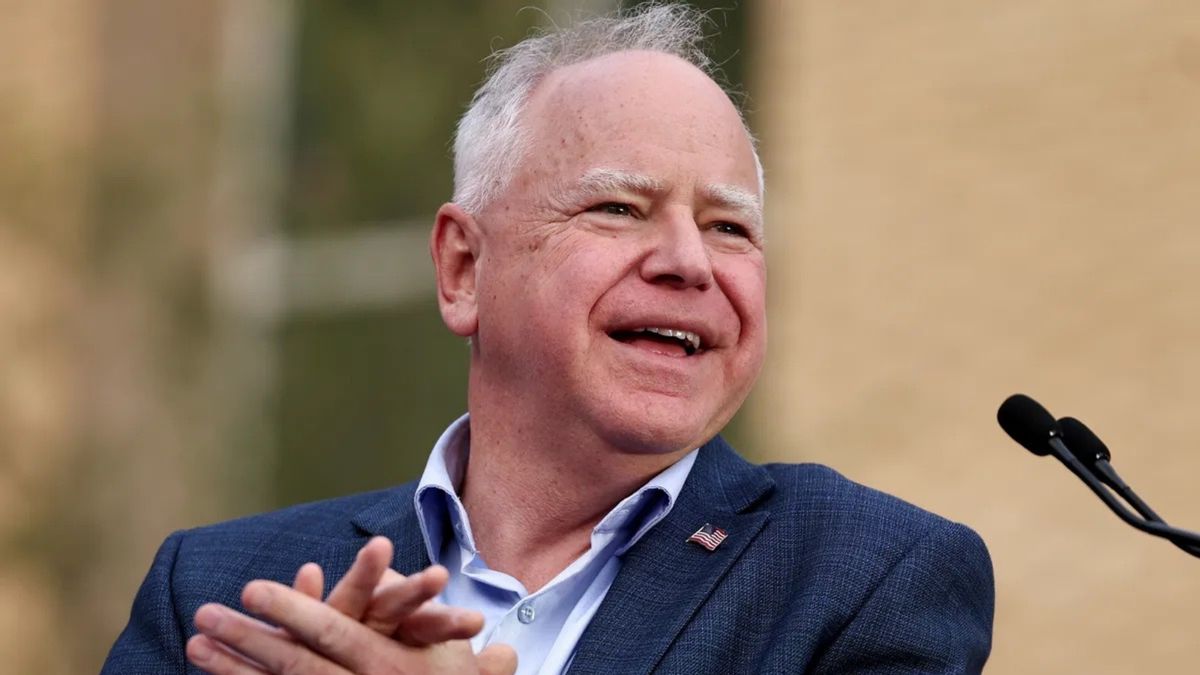 Minnesota Gov. Tim Walz, a balding white man with a ruddy complexion in a suit. 