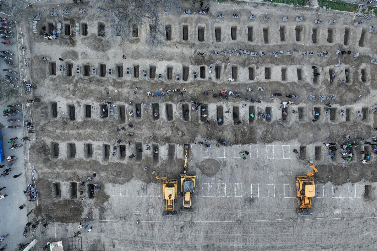 In this image, mourners dig graves during the funeral for children killed in a reported strike on a primary school in Iran's Hormozgan province in Minab on March 3, 2026.