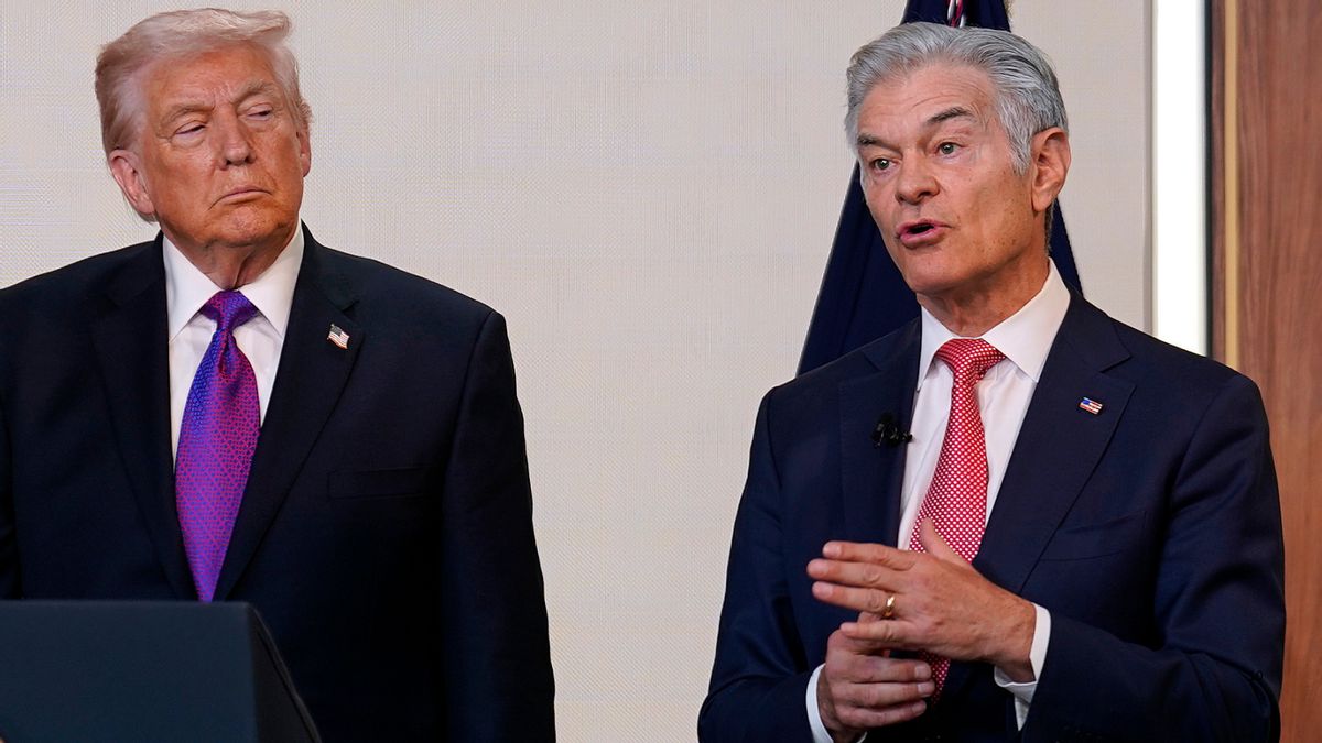 U.S. President Donald Trump looks at Mehmet Oz while Oz speaks. 