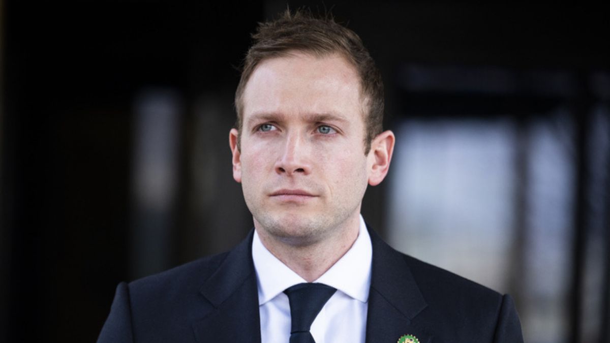 A white man with short brown hair in a suit. 