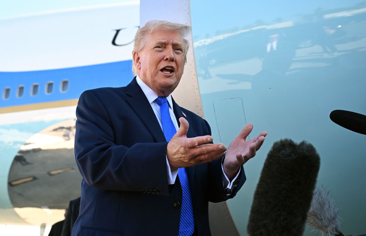 U.S. President Donald Trump speaks to reporters before boarding Air Force One at Palm Beach International Airport.