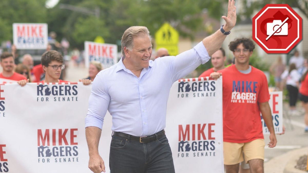A fake AI image shows an overly muscled Mike Rogers, a white man wearing a light blue button down shirt, marching in a parade
