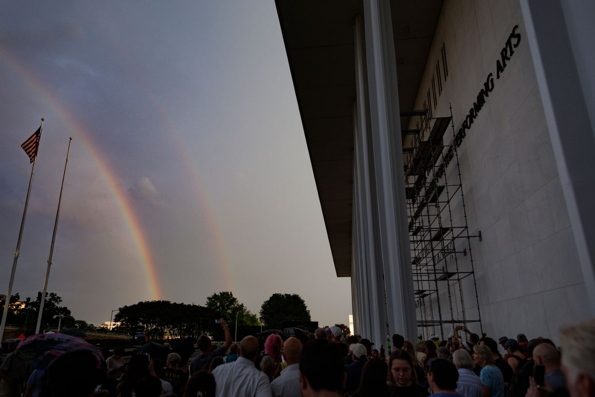Photograph shows a double rainbow alongside the Kennedy Center in Washington D.C. 