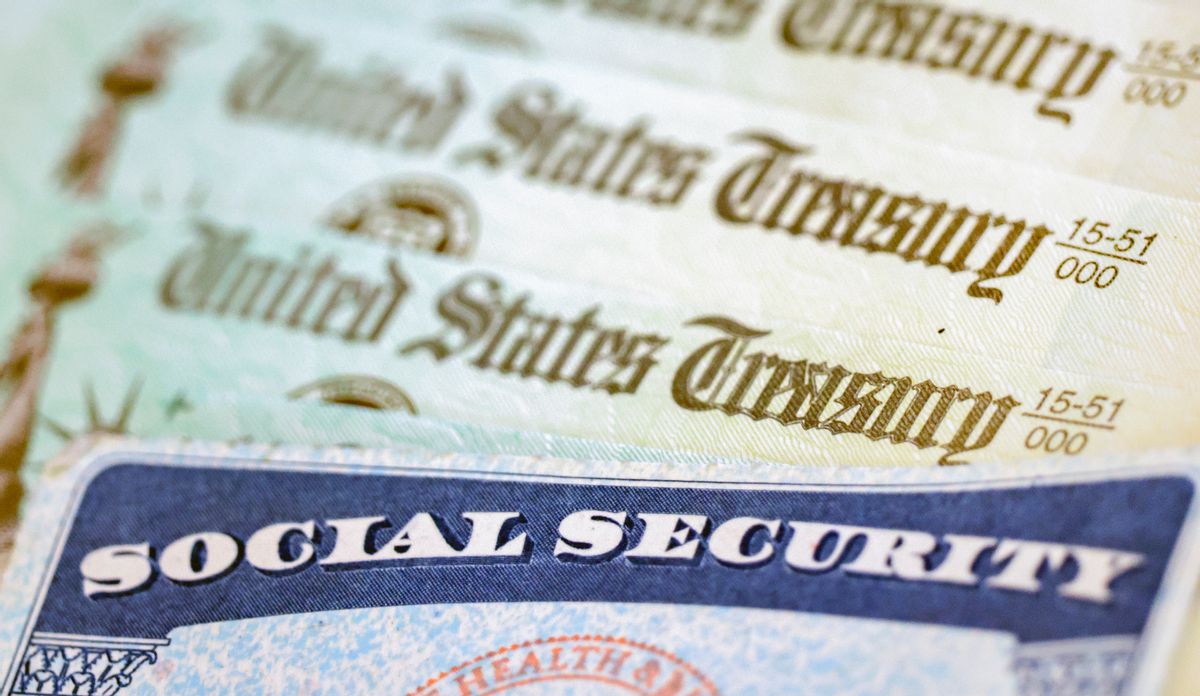 Social Security card with United States Treasury notes behind it.