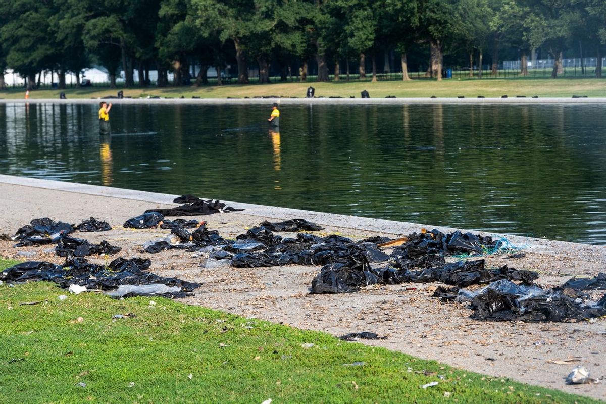 Trash and debris scattered near the Reflecting Pool. 