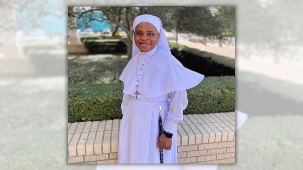 Photograph of Sister Letty. She is a black woman fully covered in all-white nun clothing. There is a rectangular garden behind her