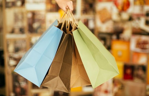 hand holding shopping bags