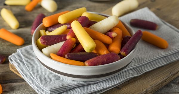 Multicolored baby carrots in a bowl