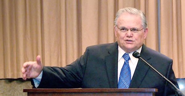 Pastor John Hagee speaking at a podium.