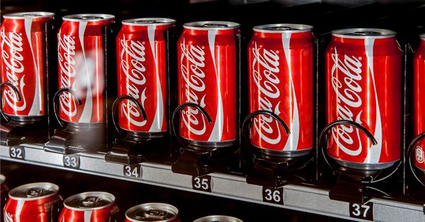 Coca-Cola cans in a vending machine